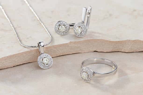Jewelry trends Elegant jewelry set of white gold ring, necklace and earrings with diamonds. Silver jewellery set with gemstones. Product still life concept