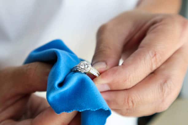 JEWELRY care hand polishing and cleaning jewelry diamond ring with micro fiber fabric